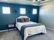 Main bedroom with blue accent wall and a queen-size bed at 19085 E 66Th Ave, Denver, CO 80249