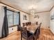 Bright dining room with hardwood floors and large windows at 6579 Poppy St, Arvada, CO 80007