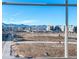 View from window showcasing a new community and mountain backdrop at 8812 Whiteclover St, Littleton, CO 80125