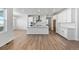 Modern kitchen with white cabinets, an island, and a double oven at 8812 Whiteclover St, Littleton, CO 80125