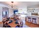 Open concept kitchen with island, white cabinets, and dining area at 11008 Vrain Ct, Westminster, CO 80031