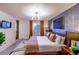 King-size bed in bright main bedroom with large window and modern decor at 11008 Vrain Ct, Westminster, CO 80031