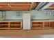 Unfinished basement with built-in shelving and workbench at 11008 Vrain Ct, Westminster, CO 80031