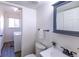 Bright bathroom features a toilet, vanity, and adjacent laundry area at 11008 Vrain Ct, Westminster, CO 80031