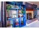 Blue shelving unit with fireplace and media console in basement at 11008 Vrain Ct, Westminster, CO 80031