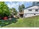 Landscaped backyard with a large grassy area and deck at 11008 Vrain Ct, Westminster, CO 80031