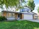 House with attached garage, manicured lawn, basketball hoop, and mature trees at 11008 Vrain Ct, Westminster, CO 80031