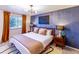 Main bedroom with a king-size bed and blue patterned wall at 11008 Vrain Ct, Westminster, CO 80031