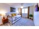 Cozy bedroom with daybed, window seating, and mid-century modern decor at 11008 Vrain Ct, Westminster, CO 80031