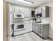 Modern kitchen with gray cabinets and white appliances at 9315 E Center Ave # 11A, Denver, CO 80247