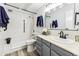 Updated bathroom with gray vanity, walk-in shower, and tiled walls at 9315 E Center Ave # 11A, Denver, CO 80247