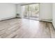 Bright living room with sliding glass door to patio and wood-look floors at 9315 E Center Ave # 11A, Denver, CO 80247