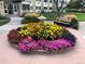 Attractive courtyard with colorful flowers and a bench at 9315 E Center Ave # 11A, Denver, CO 80247