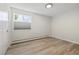 Well-lit bedroom with window, closet, and wood-look floors at 9315 E Center Ave # 11A, Denver, CO 80247