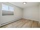Spacious bedroom with a large window and wood-look floors at 9315 E Center Ave # 11A, Denver, CO 80247