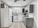 Modern kitchen with gray cabinets and white appliances at 9315 E Center Ave # 11A, Denver, CO 80247