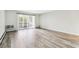 Spacious living room featuring wood-look floors and a sliding glass door at 9315 E Center Ave # 11A, Denver, CO 80247