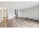Open living area with wood-look floors and views into the kitchen at 9315 E Center Ave # 11A, Denver, CO 80247