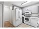 Modern kitchen with gray cabinets and white appliances at 9315 E Center Ave # 11A, Denver, CO 80247