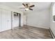 Bright bedroom with ceiling fan, double closet, and wood-look floors at 9315 E Center Ave # 11A, Denver, CO 80247