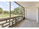 Bright screened porch with tiled floor, overlooking a lush green yard at 9315 E Center Ave # 11A, Denver, CO 80247
