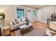 Light-filled living room with hardwood floors and comfy seating at 1044 S Corona St, Denver, CO 80209