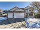 Two-story house with a three-car garage and snow-covered front yard at 850 Quarterhorse Trl, Castle Rock, CO 80104