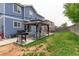 Spacious backyard with covered patio, grill, and grassy area at 493 N 48Th Ave, Brighton, CO 80601