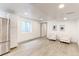 Finished basement with seating area and adjacent kitchen at 493 N 48Th Ave, Brighton, CO 80601