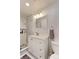 Modern bathroom featuring white vanity, marble shower, and pebble floor at 493 N 48Th Ave, Brighton, CO 80601