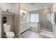Modern bathroom with tiled shower, soaking tub, and dual vanity at 493 N 48Th Ave, Brighton, CO 80601