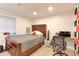 Bedroom with wooden bedframe, desk, and red accent wall at 493 N 48Th Ave, Brighton, CO 80601
