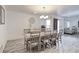 Dining room with wooden table, chairs, and a view of the living area and door to the backyard at 493 N 48Th Ave, Brighton, CO 80601