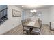 Dining room featuring a long wooden table with chairs and stylish wall art at 493 N 48Th Ave, Brighton, CO 80601