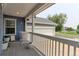 Inviting front porch with white railing, potted plants, and a welcome sign at 493 N 48Th Ave, Brighton, CO 80601