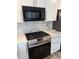 Updated kitchen with stainless steel appliances, white cabinets, and a tile backsplash at 493 N 48Th Ave, Brighton, CO 80601