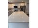 Close-up of the kitchen's large white island with ample counter space at 493 N 48Th Ave, Brighton, CO 80601