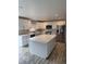 Modern kitchen with white cabinets, stainless steel appliances, and a large island at 493 N 48Th Ave, Brighton, CO 80601