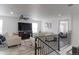 Upstairs living room with fireplace, ceiling fan, and access to a balcony at 493 N 48Th Ave, Brighton, CO 80601