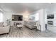Spacious living room with gray couches, wood-look flooring, and a fireplace at 493 N 48Th Ave, Brighton, CO 80601