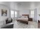 Spacious main bedroom with wood-look flooring, large windows, and a cozy sitting area at 493 N 48Th Ave, Brighton, CO 80601