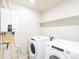 Laundry room with Whirlpool washer and dryer, and water heater at 22350 E 8Th Pl, Aurora, CO 80018