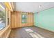 Open living room with wood paneling and a built-in shelving unit at 746 Bow Mountain Rd, Boulder, CO 80304