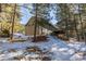 Two-story home exterior with wood siding and snowy yard at 746 Bow Mountain Rd, Boulder, CO 80304