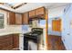 View of kitchen stove and a partial view of the dining room at 746 Bow Mountain Rd, Boulder, CO 80304