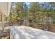 Snowy deck with wooded views at 746 Bow Mountain Rd, Boulder, CO 80304