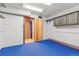 Unfinished basement with blue floor and cabinets at 746 Bow Mountain Rd, Boulder, CO 80304