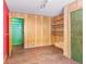Bedroom with wood paneled walls, built in shelving and green closet at 746 Bow Mountain Rd, Boulder, CO 80304