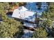 Aerial view of house, deck, and snowy backyard at 746 Bow Mountain Rd, Boulder, CO 80304
