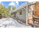 Home's exterior with deck and snowy yard at 746 Bow Mountain Rd, Boulder, CO 80304